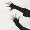 Bianca fingerless noir gloves with alligator-embossed suede back, tonal noir leather palm, silk lining, and open fingertips, back-of-hand view