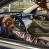 Amalfi Homme cognac woven lambskin driving gloves with hand-braided palm, perforated fingers, and snap-strap cuff, back-of-hand view
