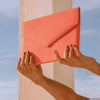 Vesper coral snakeskin-embossed (cobra) leather envelope clutch, front view